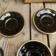 Set of 9 cups and sub-cups in black ceramic and colored gold border