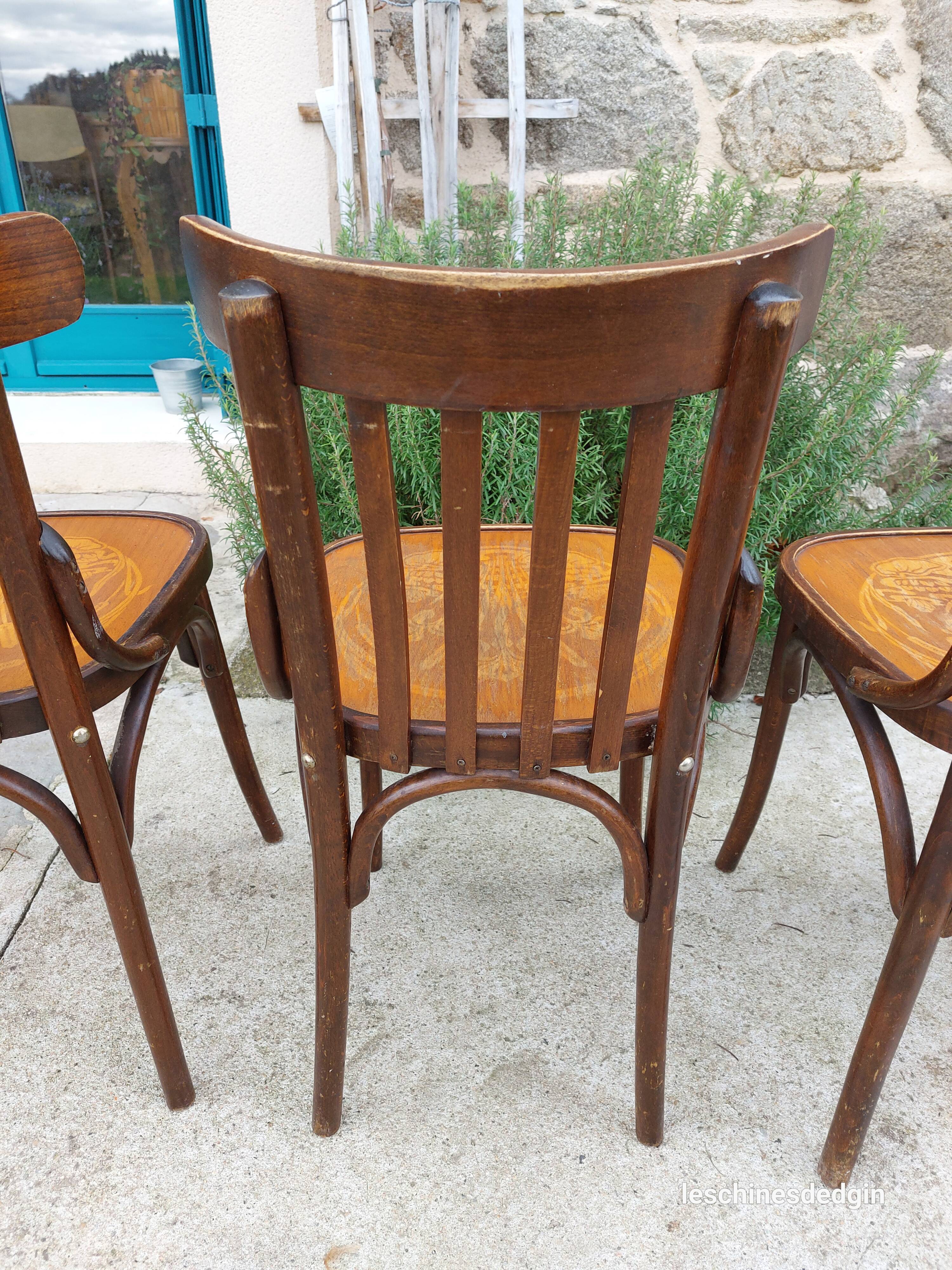 4 bentwood bistro chairs with a pattern on the seat