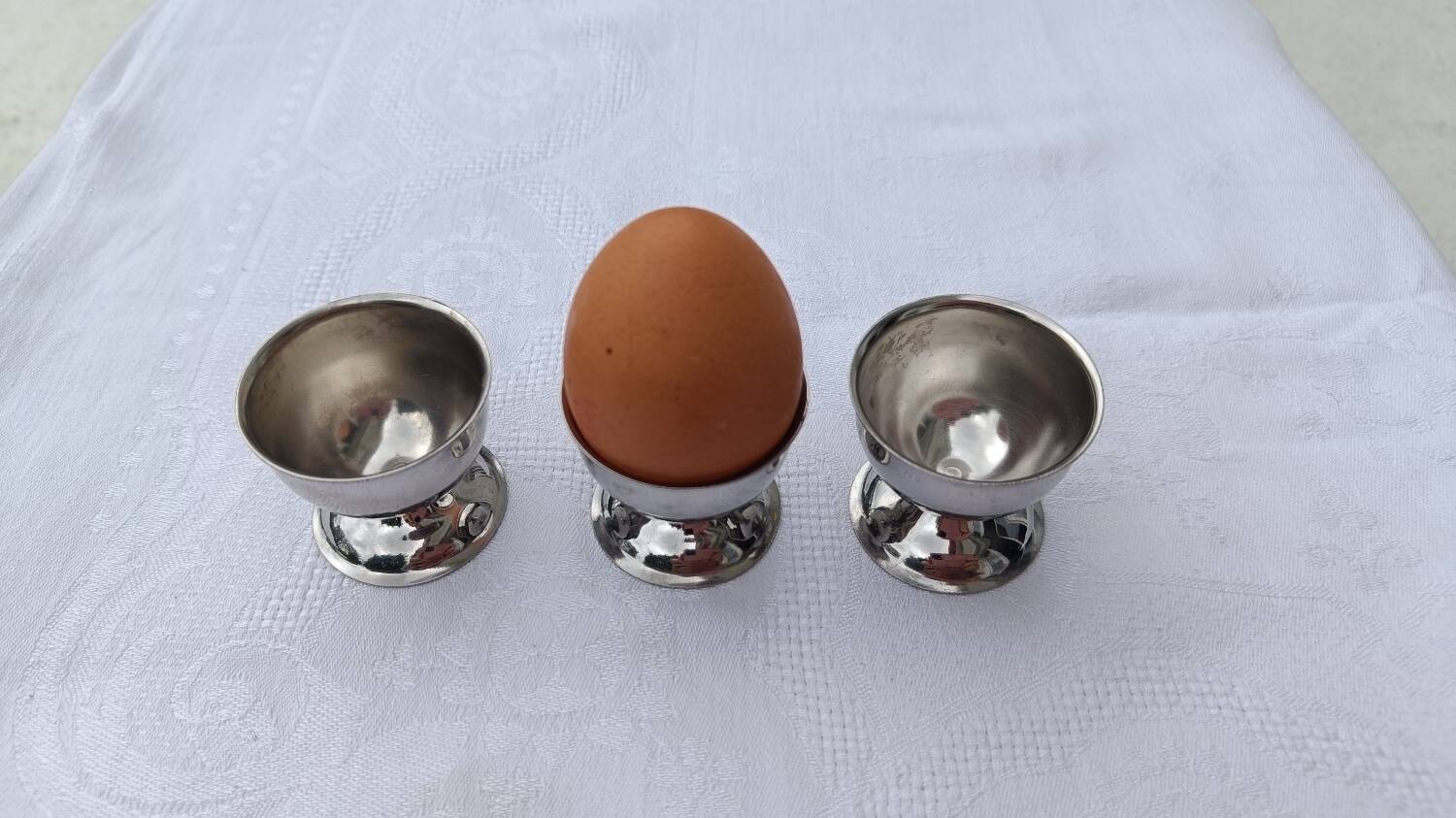 A set of 3 egg cups by Guy Degrenne.