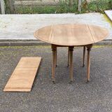 Renovated Louis Philippe round extendable dining table with leaves from the 18th century.