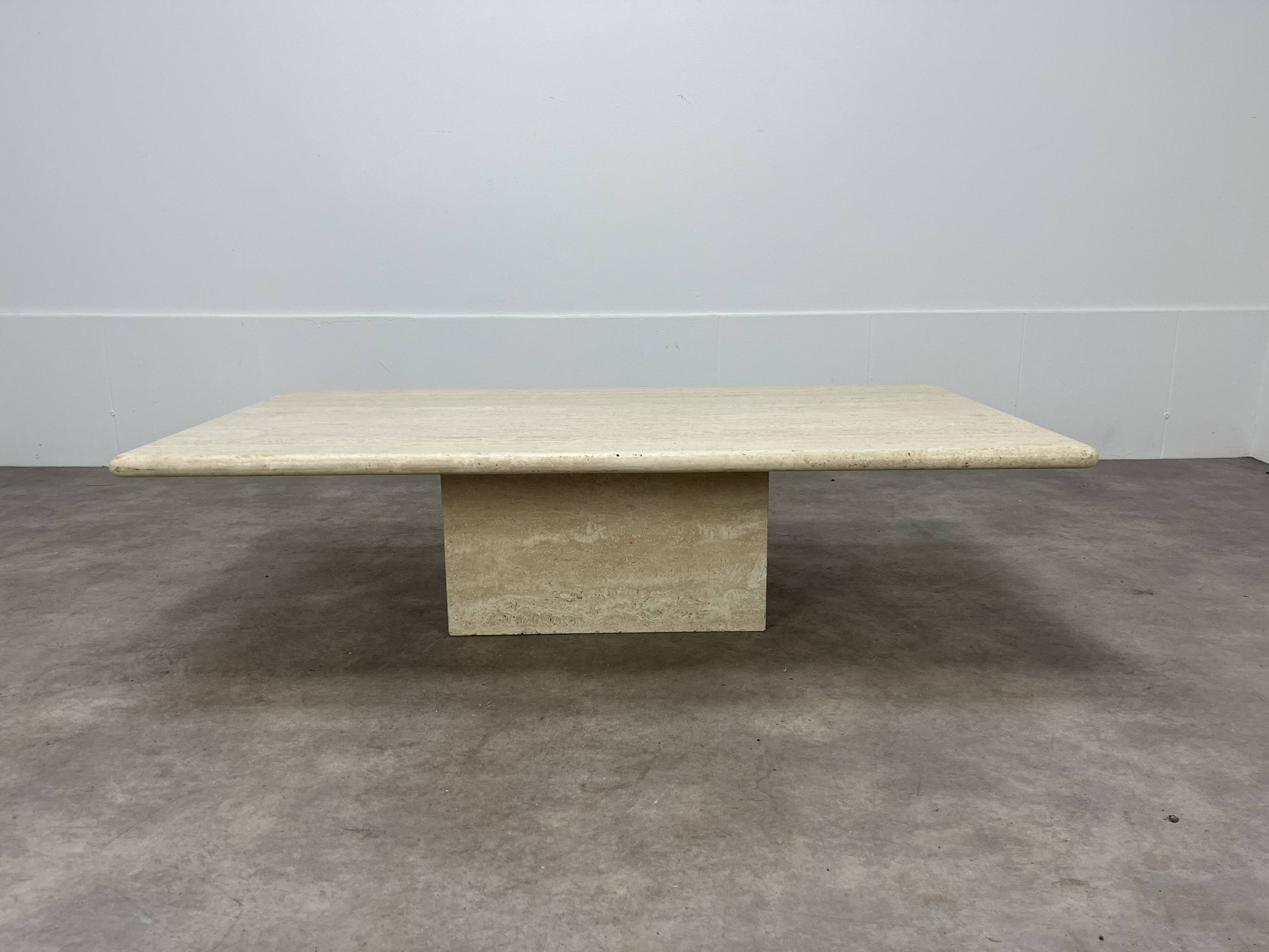 Rectangular travertine coffee table with central leg