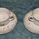 Two MOUSTIER cups decorated with flowers signed