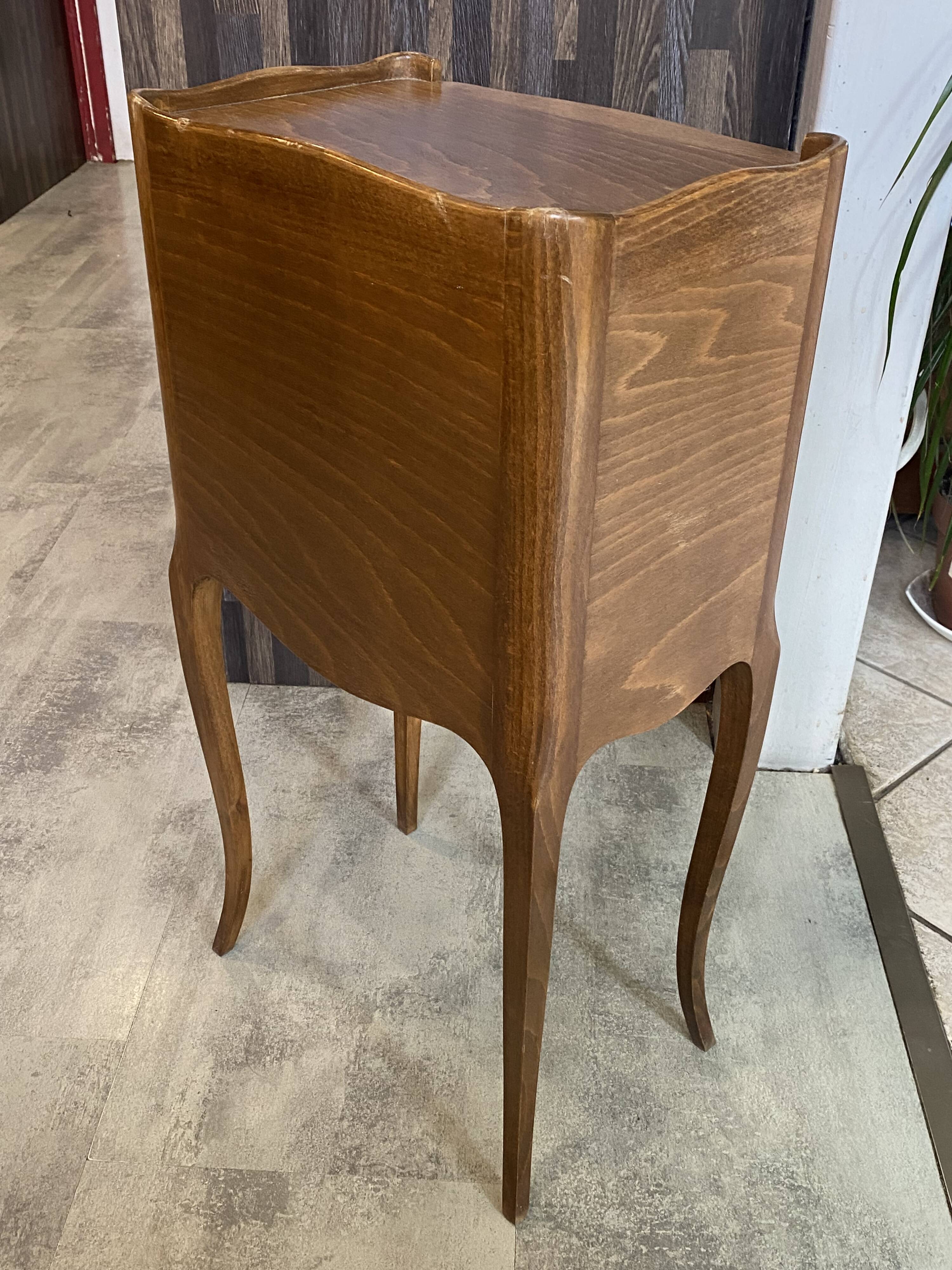 A bedside table with a drawer and a niche in Louis XV style.