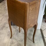 A bedside table with a drawer and a niche in Louis XV style.