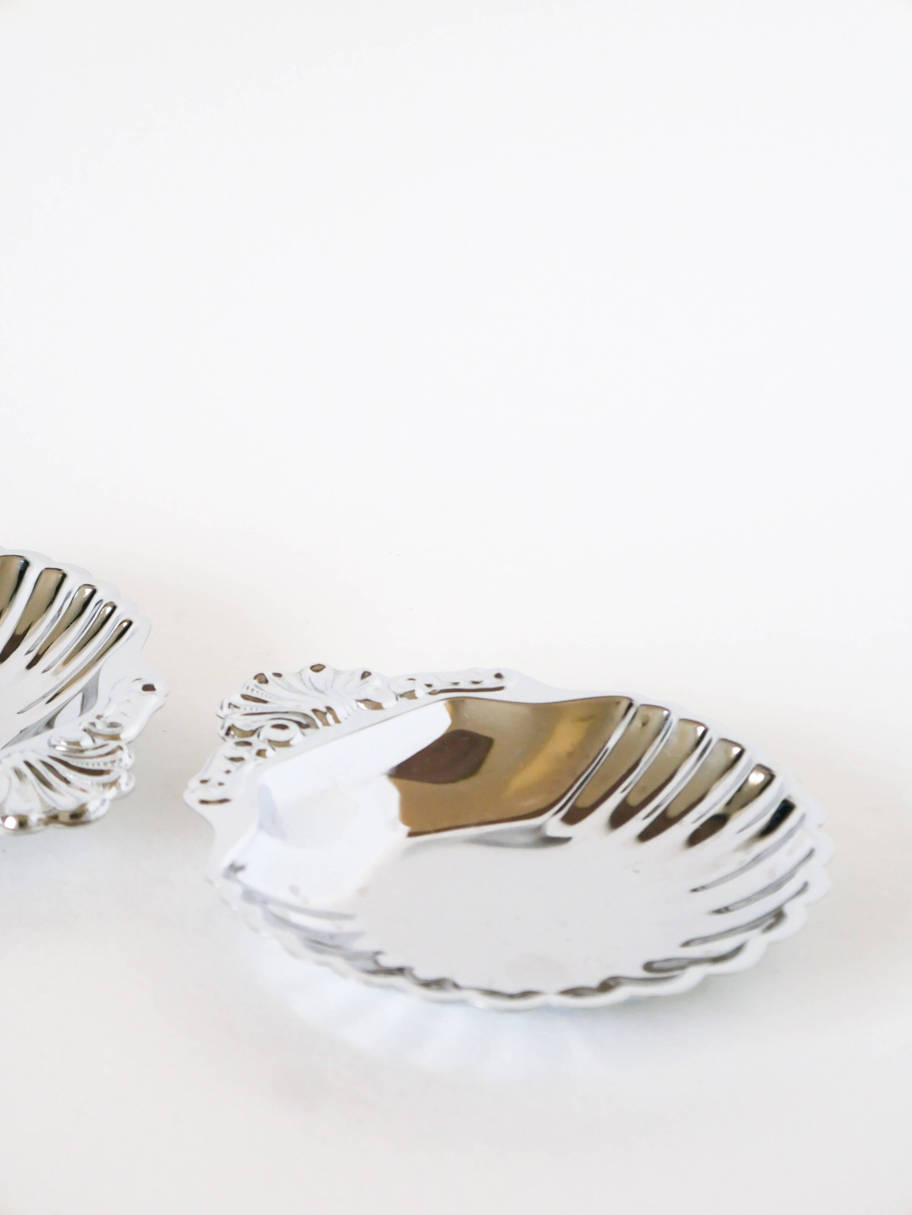 Pair of worked stainless steel shell trinket trays, 1970