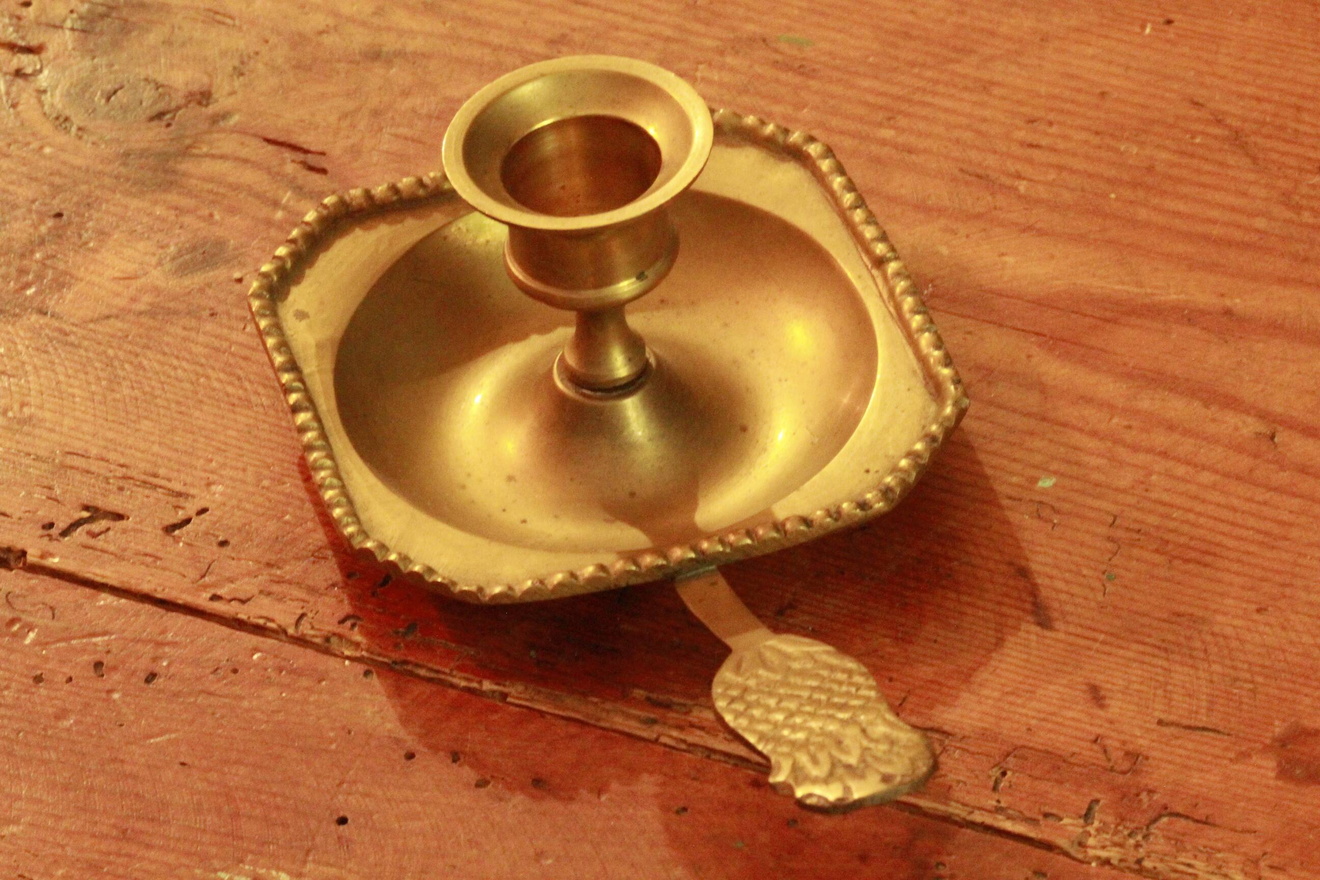 Old brass hand candle holder