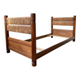 Brutalist style bed with chain and straw