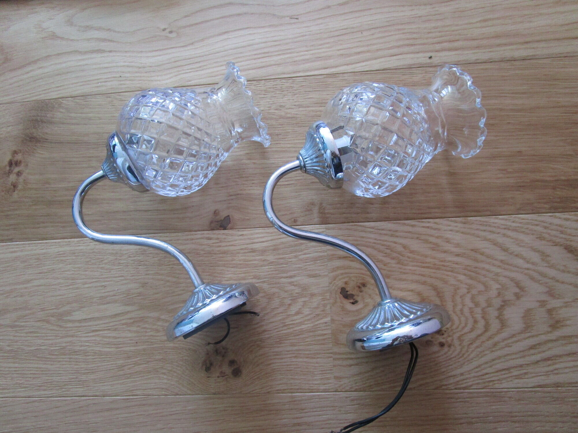 Pair of wall brackets in chromed metal and cut glass