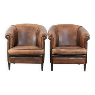 Set of 2 sturdy vintage sheepskin club armchairs with a beautiful patina