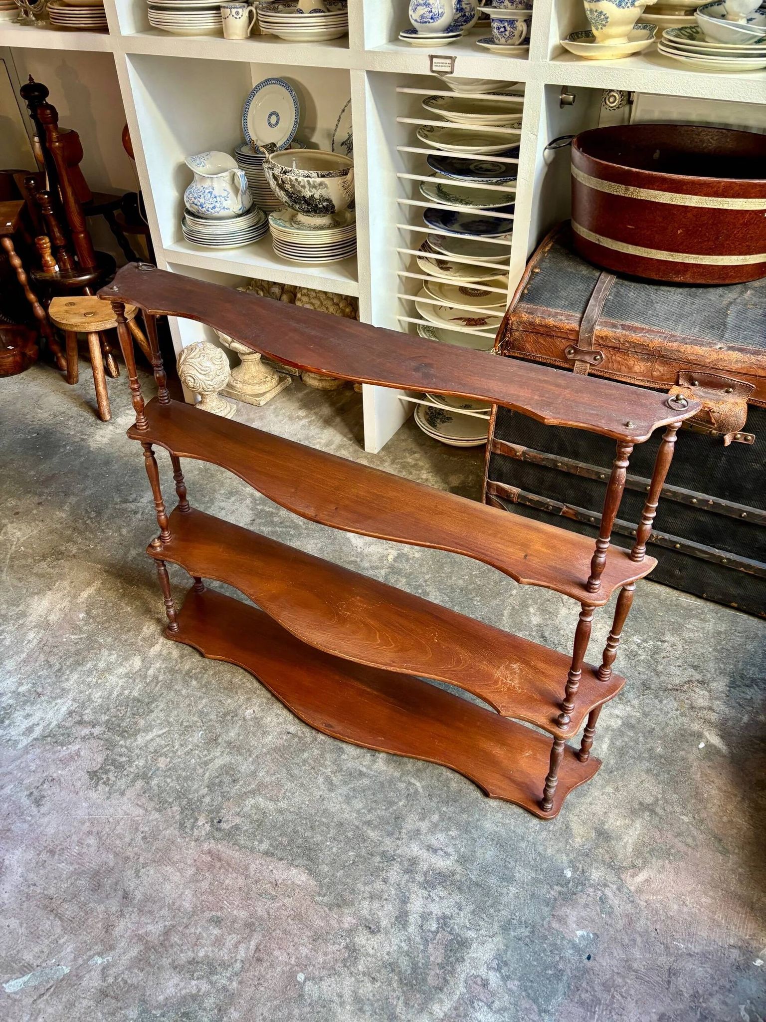 Curved and turned wooden wall shelf