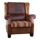 Very large worn sheepskin wing chair with a checked seat cushion