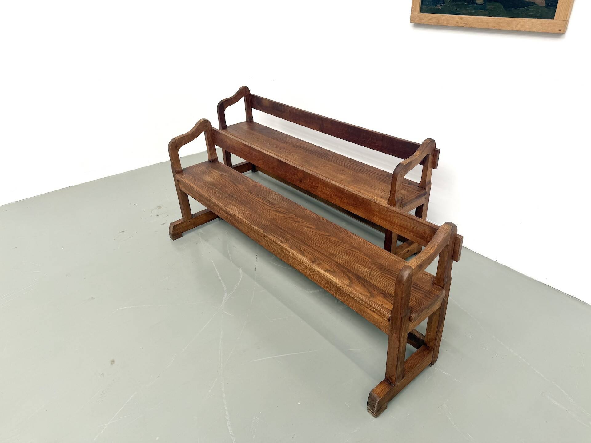 Pair of communal benches in solid oak, 1950s.