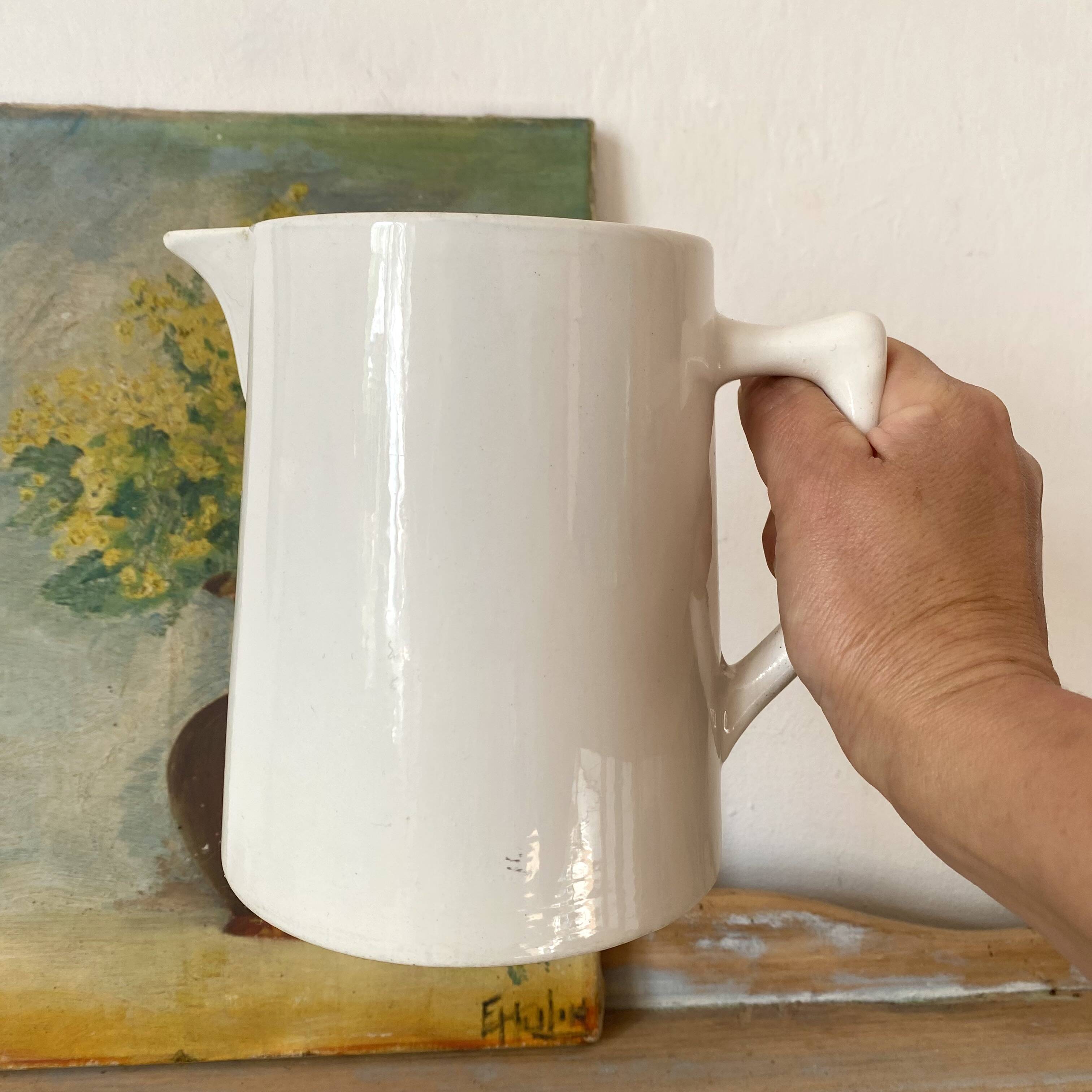 Old white earthenware jug