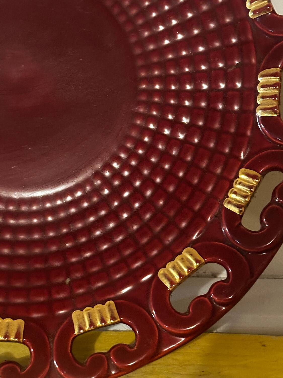 Burgundy and gold openwork plate in ceramic from Saint-Clement, 1950s.