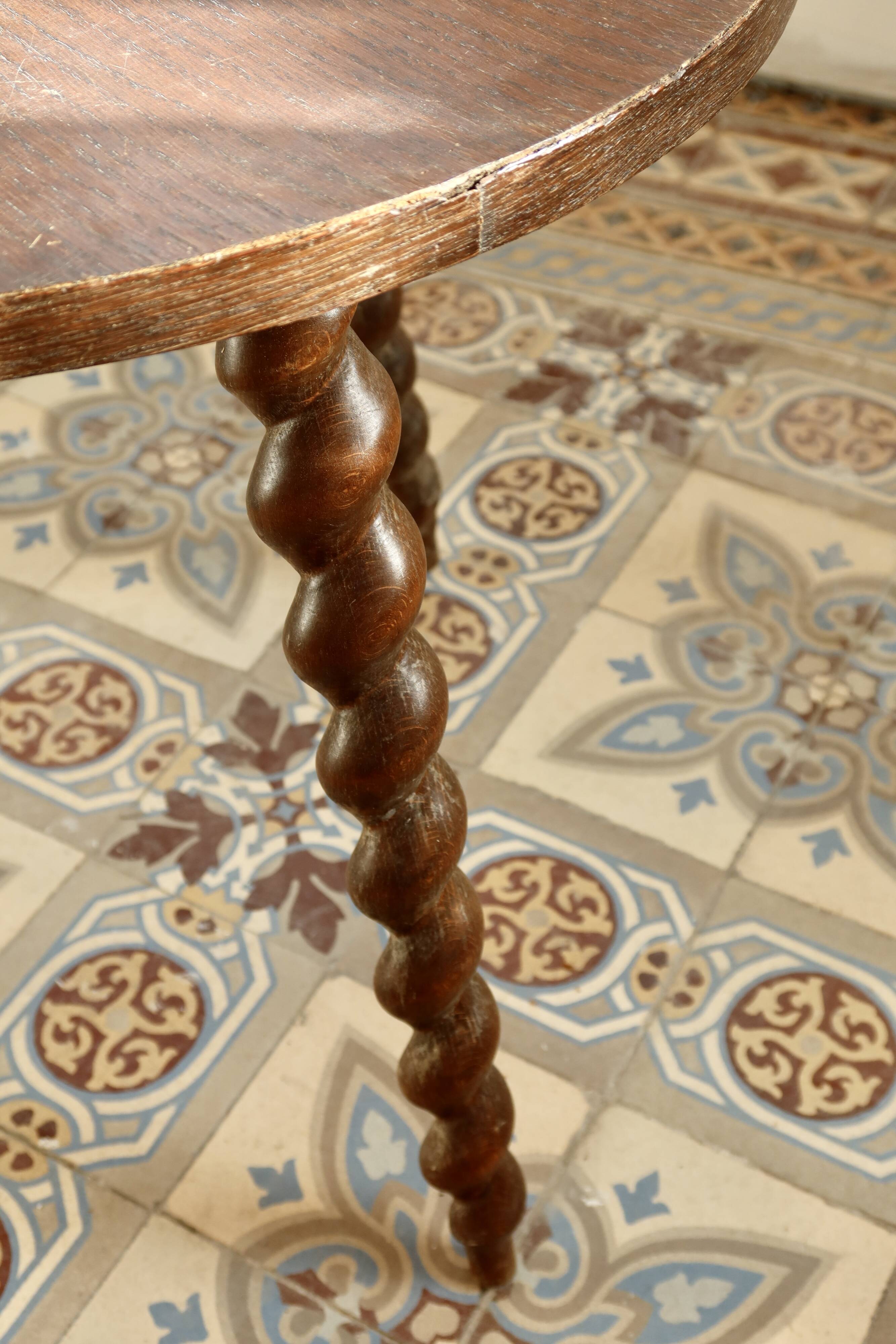 Vintage circular side table in wood with turned legs.