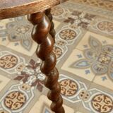 Vintage circular side table in wood with turned legs.