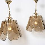 Pair of vintage pendant lights in smoked glass and gold metal, Hollywood style.