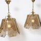 Pair of vintage pendant lights in smoked glass and gold metal, Hollywood style.