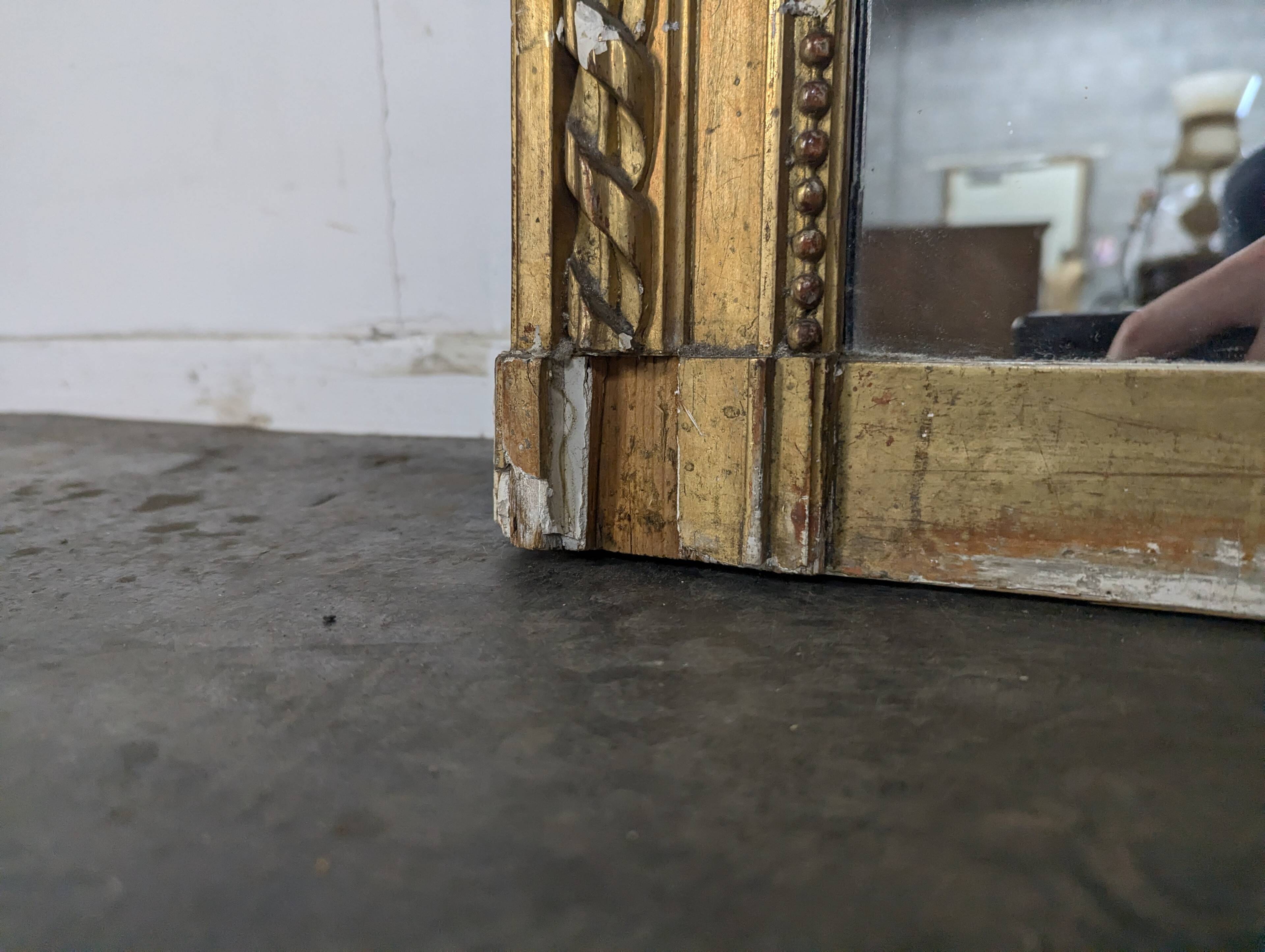 Golden Louis XVI style mirror with bouquet and shells.