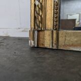 Golden Louis XVI style mirror with bouquet and shells.