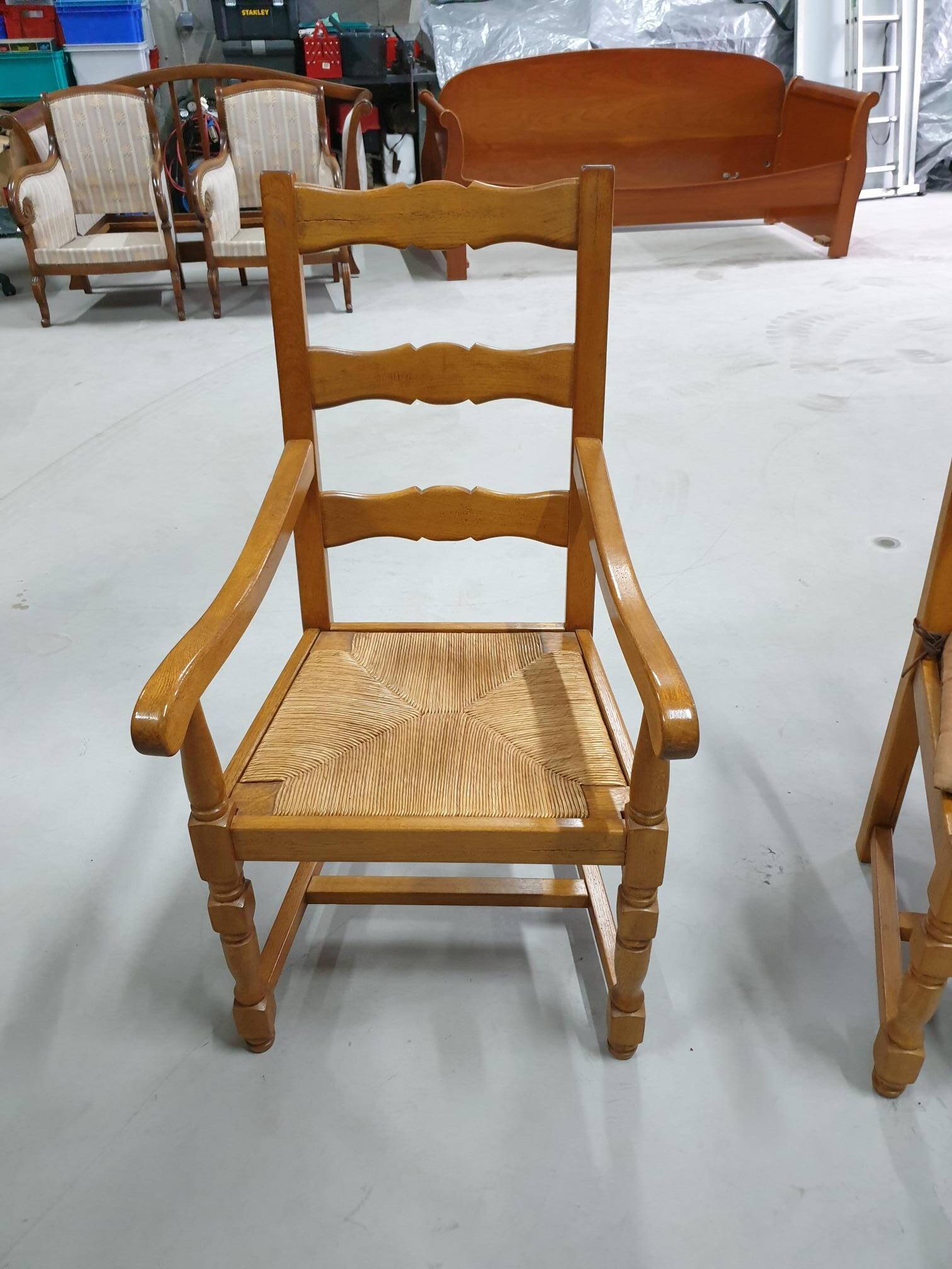 Two oak armchairs with straw seats