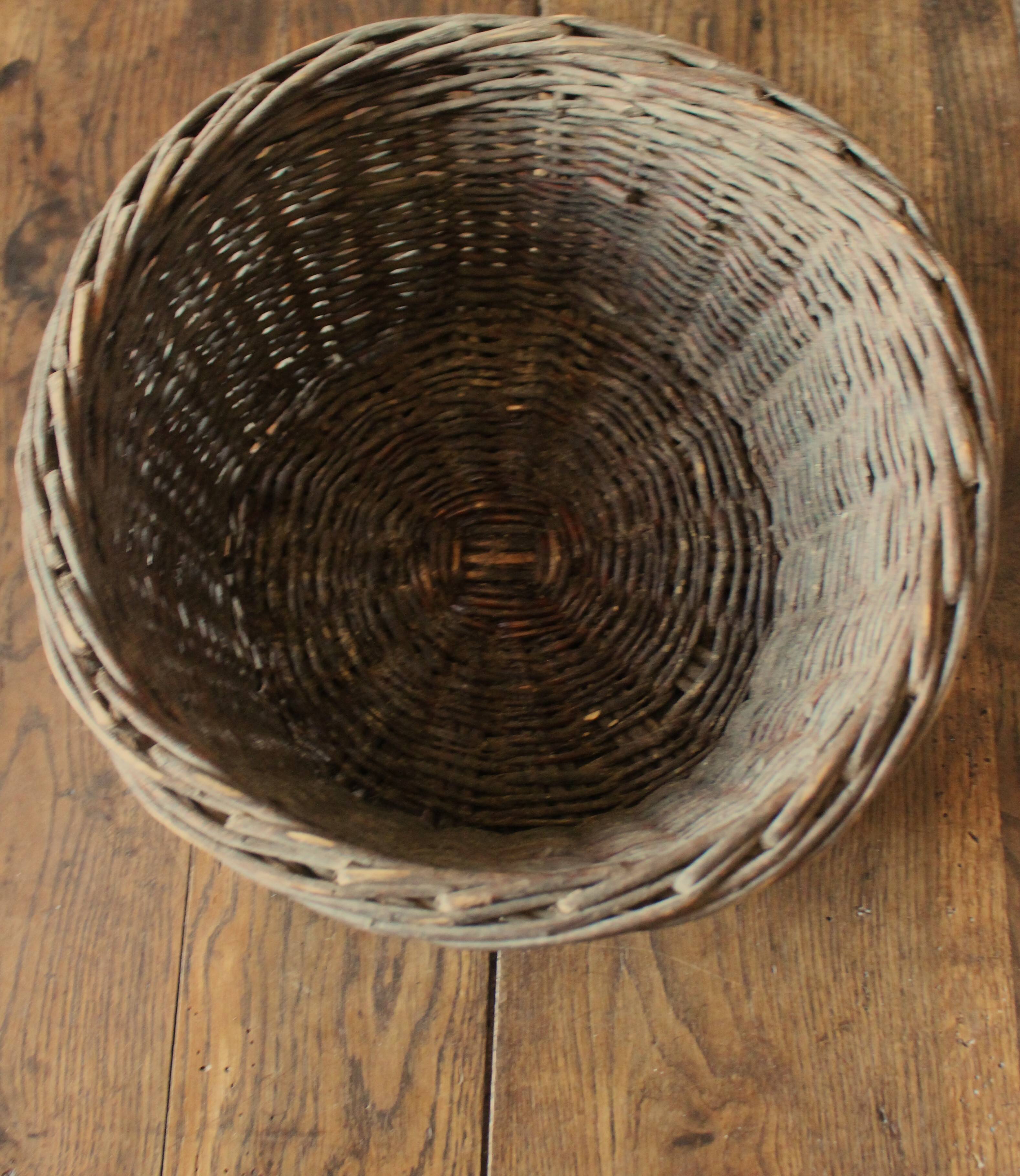 Round wicker basket with a patina