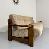 Old 3-seater sofa in solid wood, Maison Regain design, from the 70s.