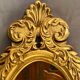 Oval view mirror in gilded wood with leafy decoration in Regency style
