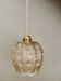 Suspension globe vintage en verre ambré
