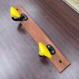 Coat rack with 2 yellow and black hooks