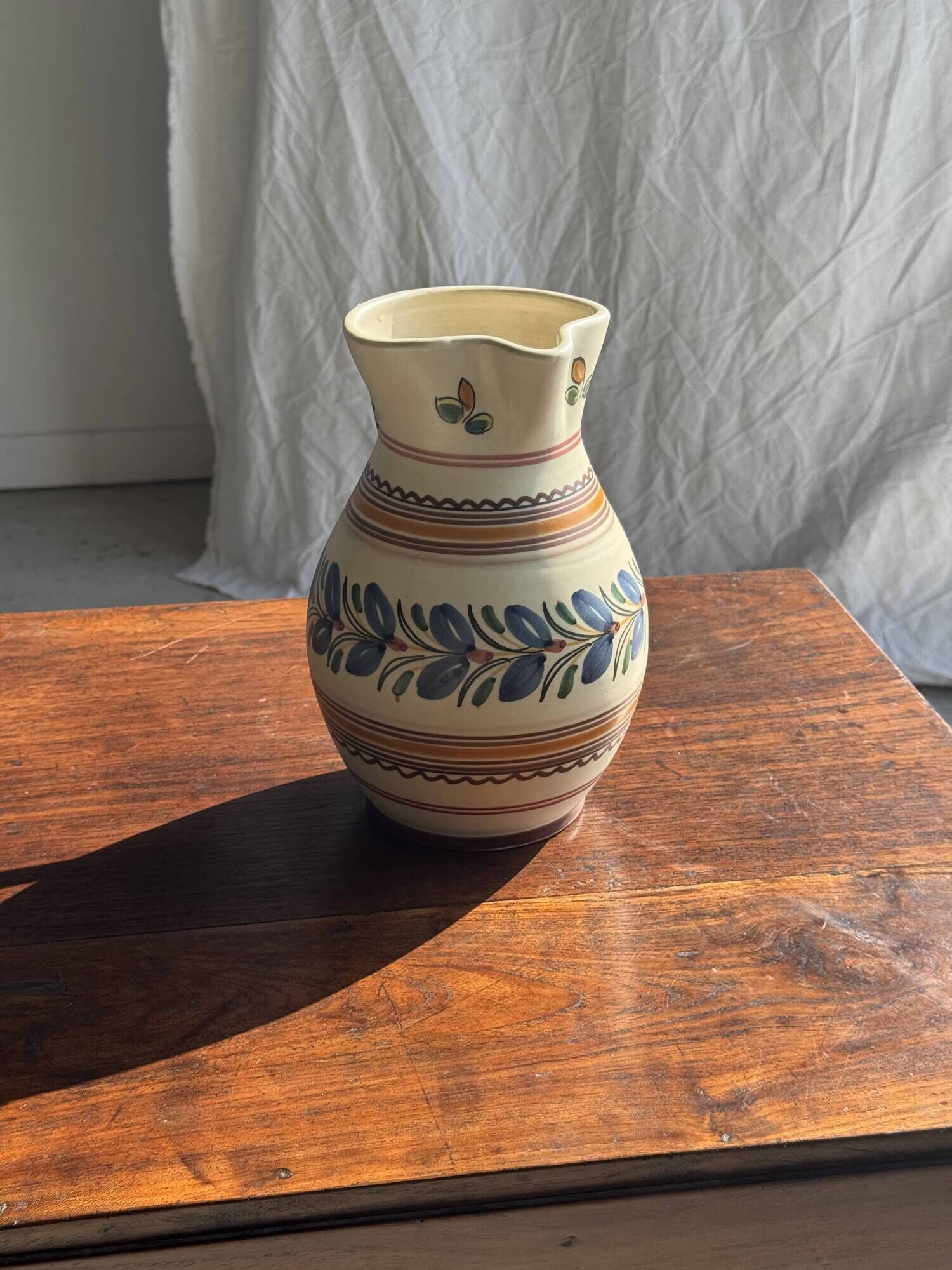 Beige carafe with stylized blue flower friezes