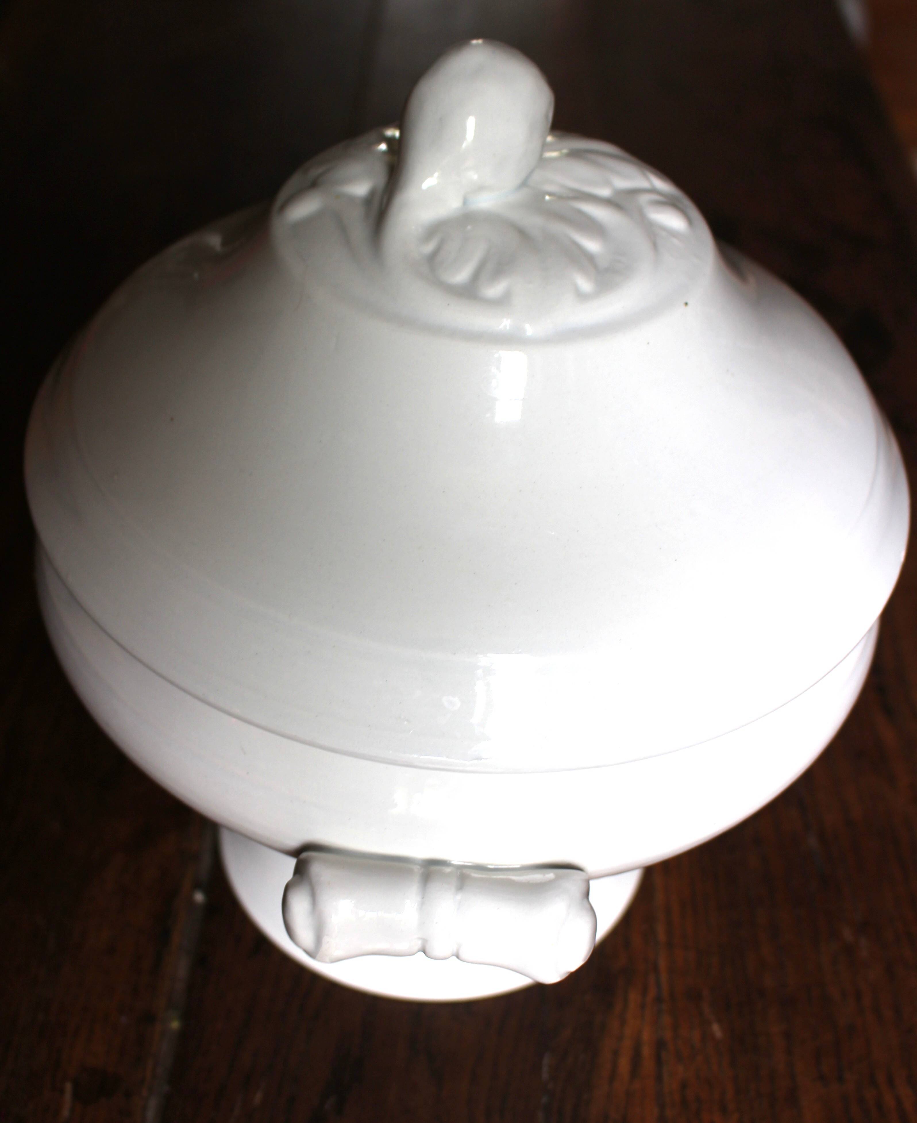Antique soup tureen, white earthenware, with stopper decoration.