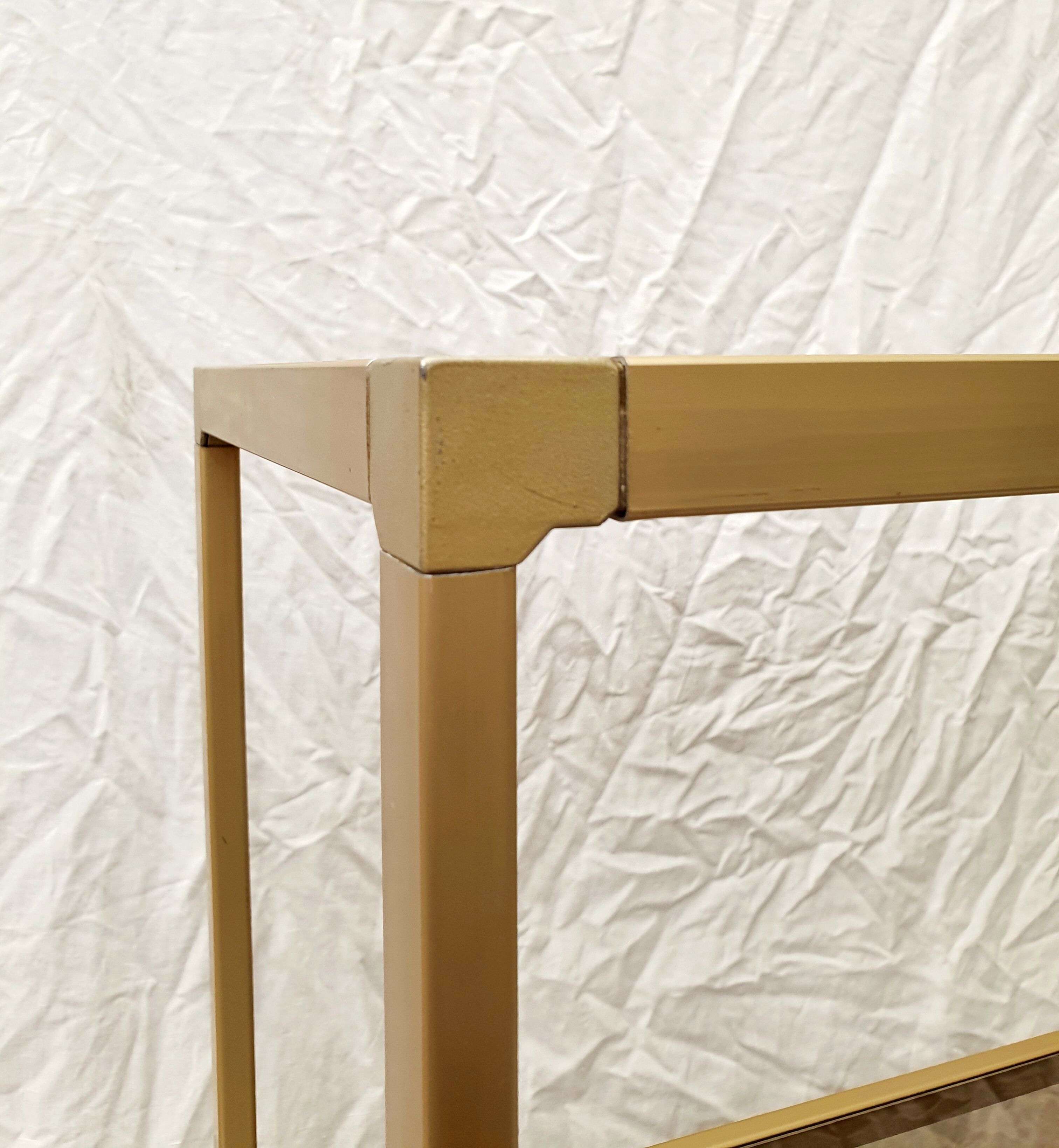 Golden metal shelf and smoked glass