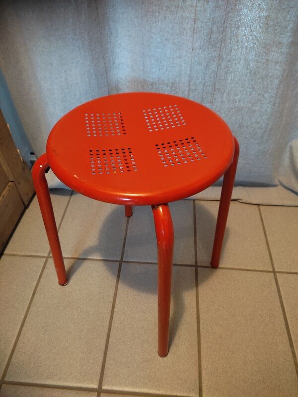 Red patinated metal stool