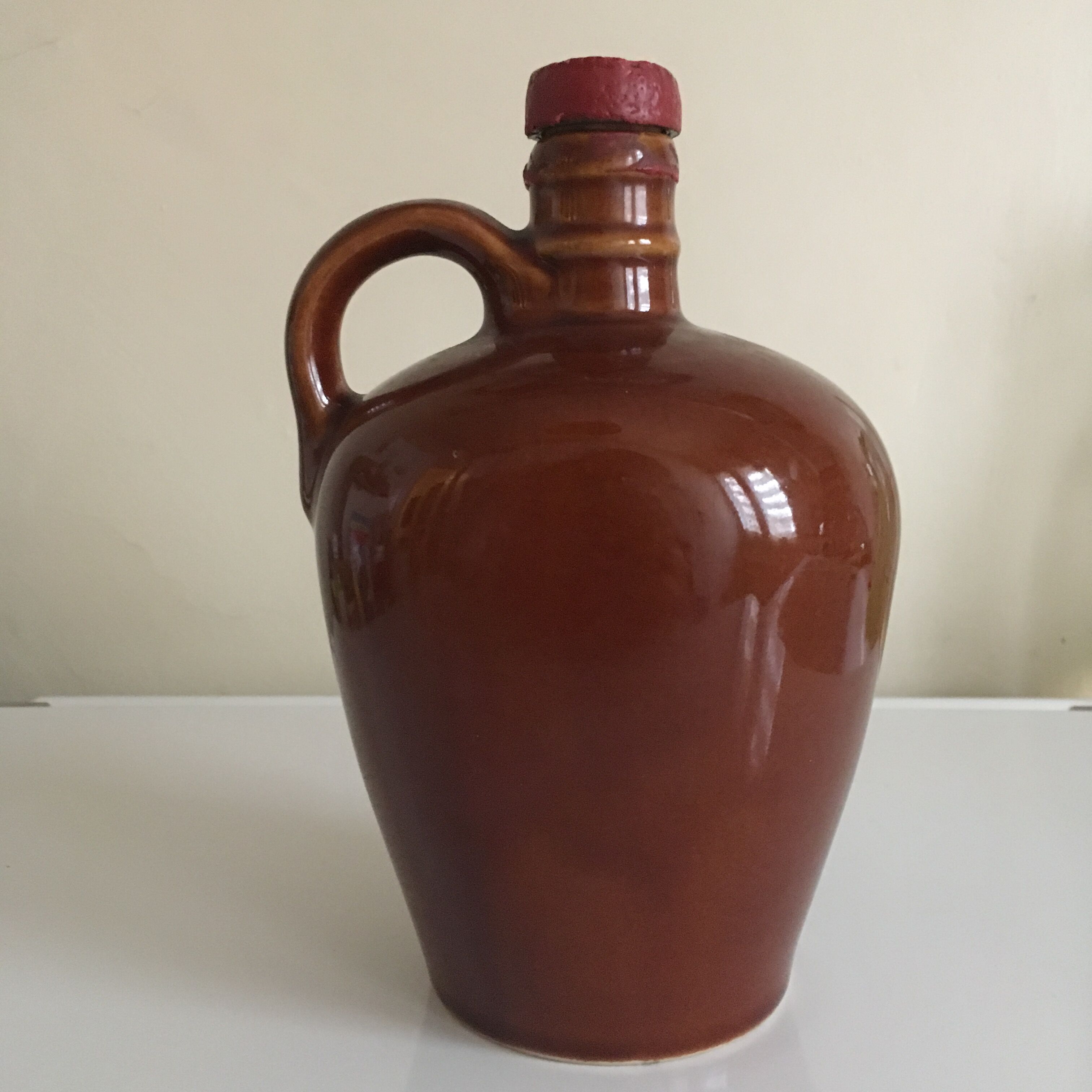 Old bottle of Calvados in sandstone