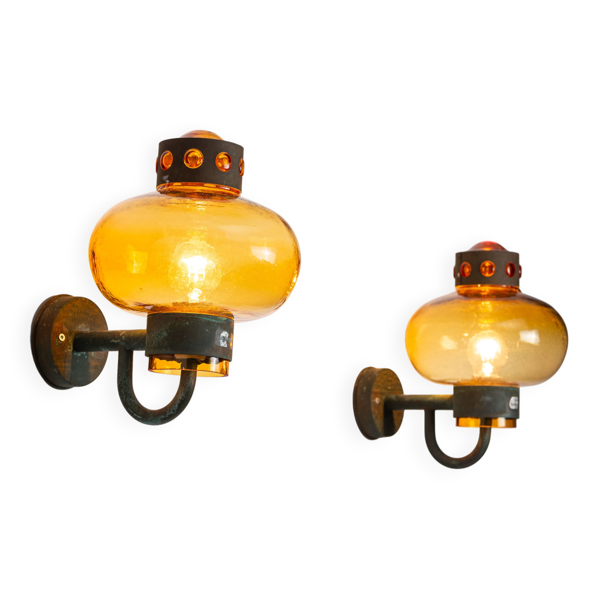 Pair of brass wall lamps with decorated amber coloured shades