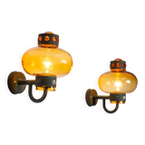 Pair of brass wall lamps with decorated amber coloured shades