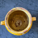 Old candied pot in yellow glazed terracotta