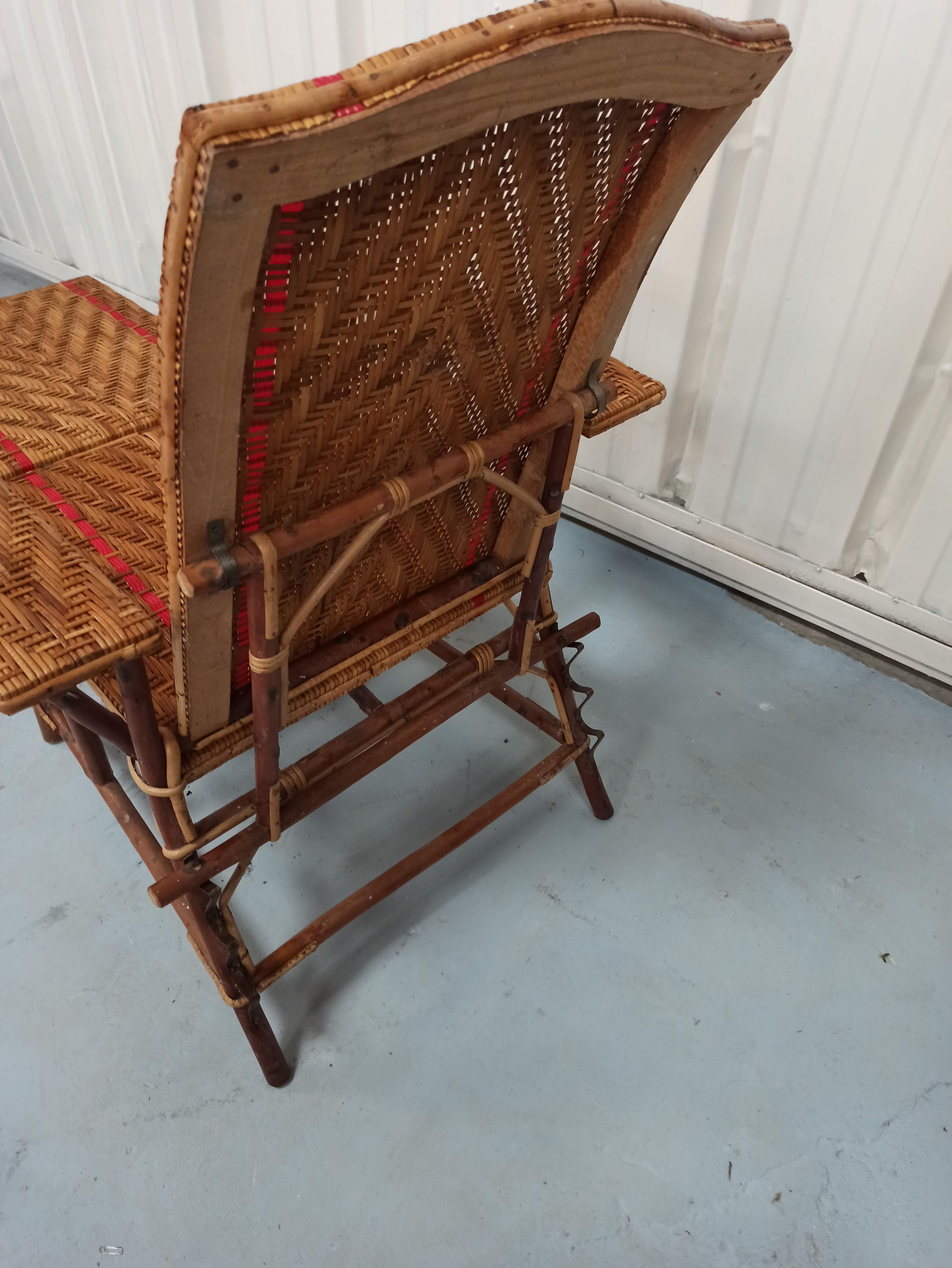 Sunbathing sunbathing in wicker rattan wood deckchair red lounger
