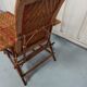 Sunbathing sunbathing in wicker rattan wood deckchair red lounger