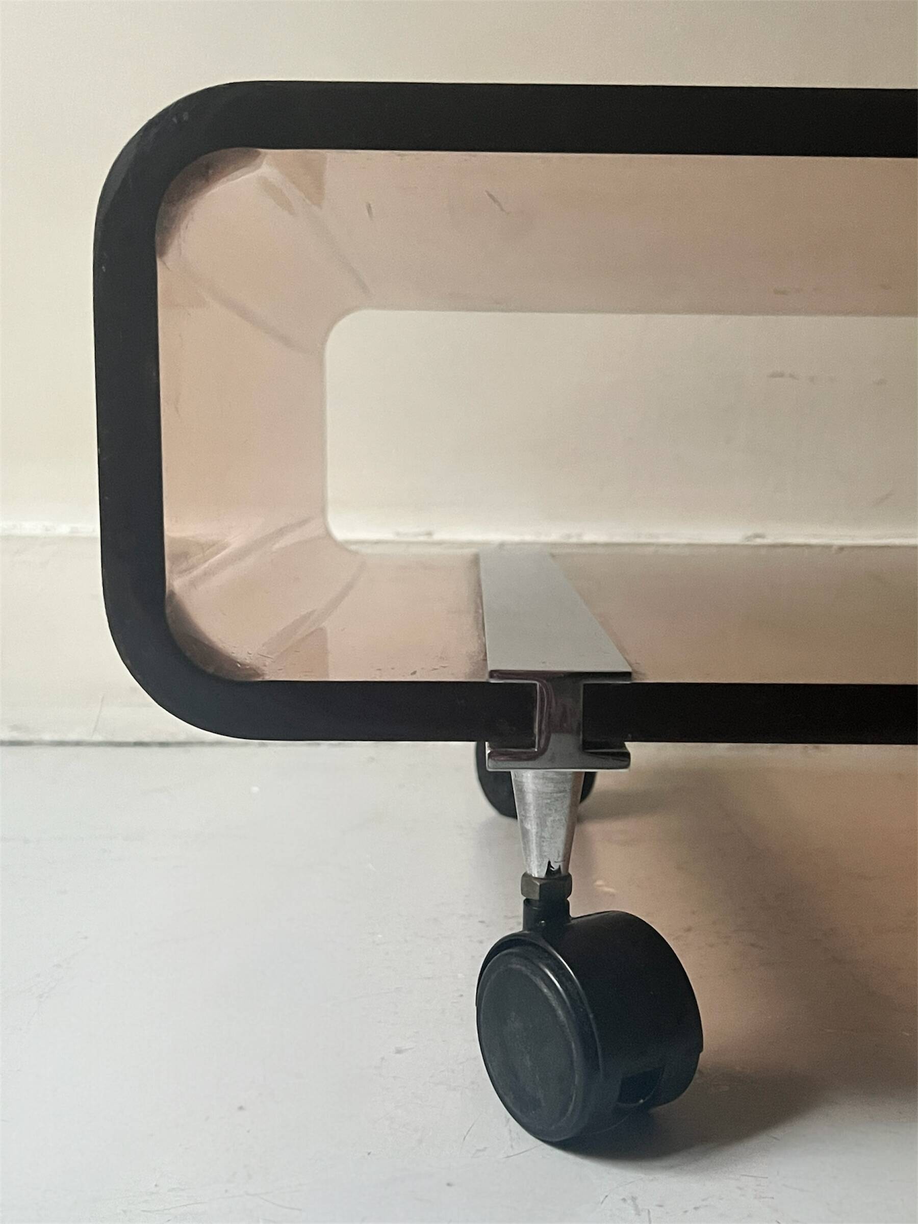 Smoked plexiglass coffee table on wheels, Roche Bobois design 1970.