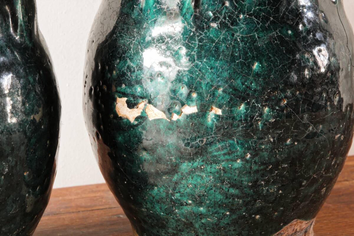 Set of two Chinese green glazed stoneware storage jars.