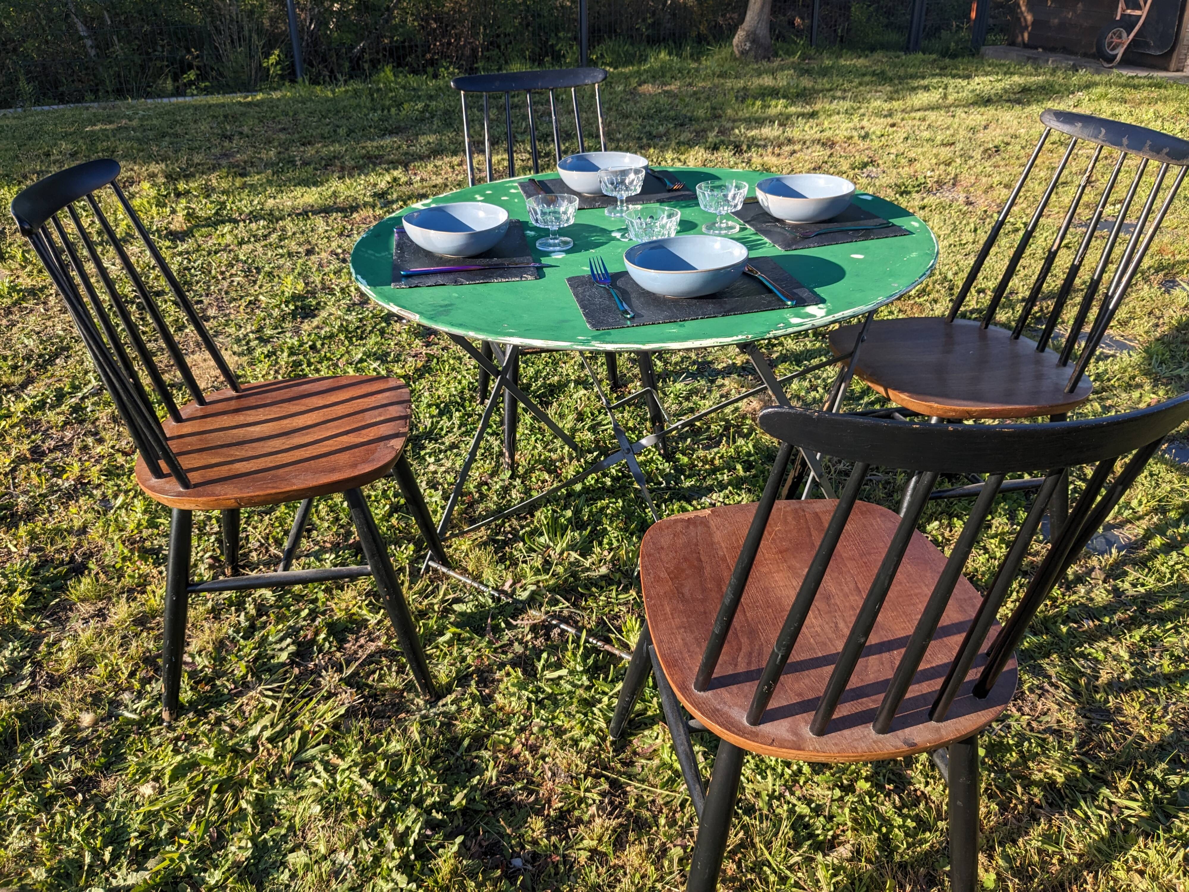 Antique round folding garden table with a green patina.