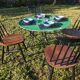 Antique round folding garden table with a green patina.
