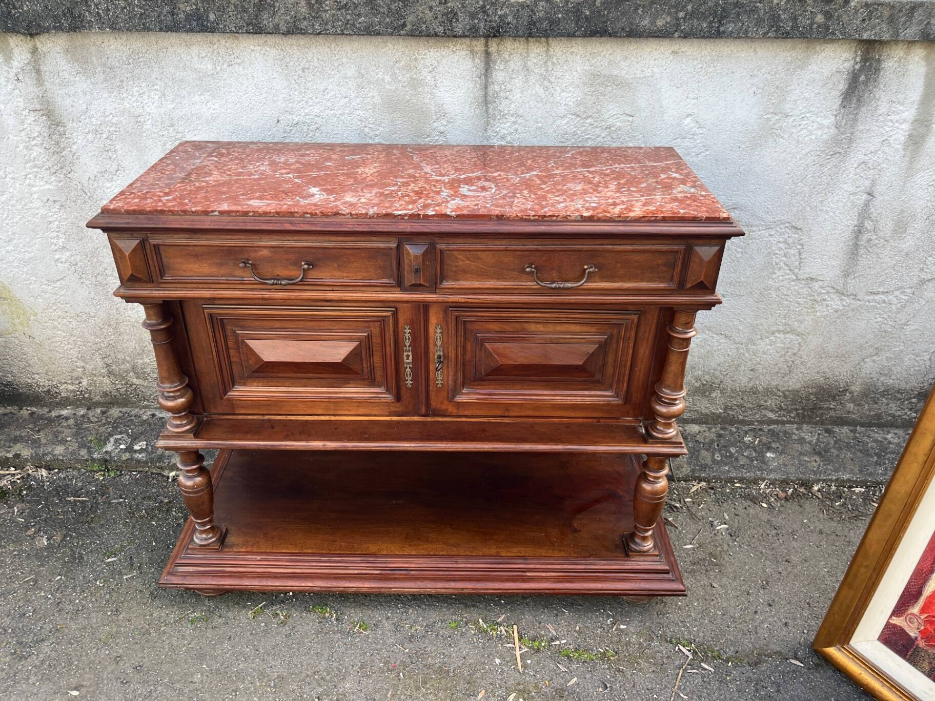Henri II style console table with a red marble top.