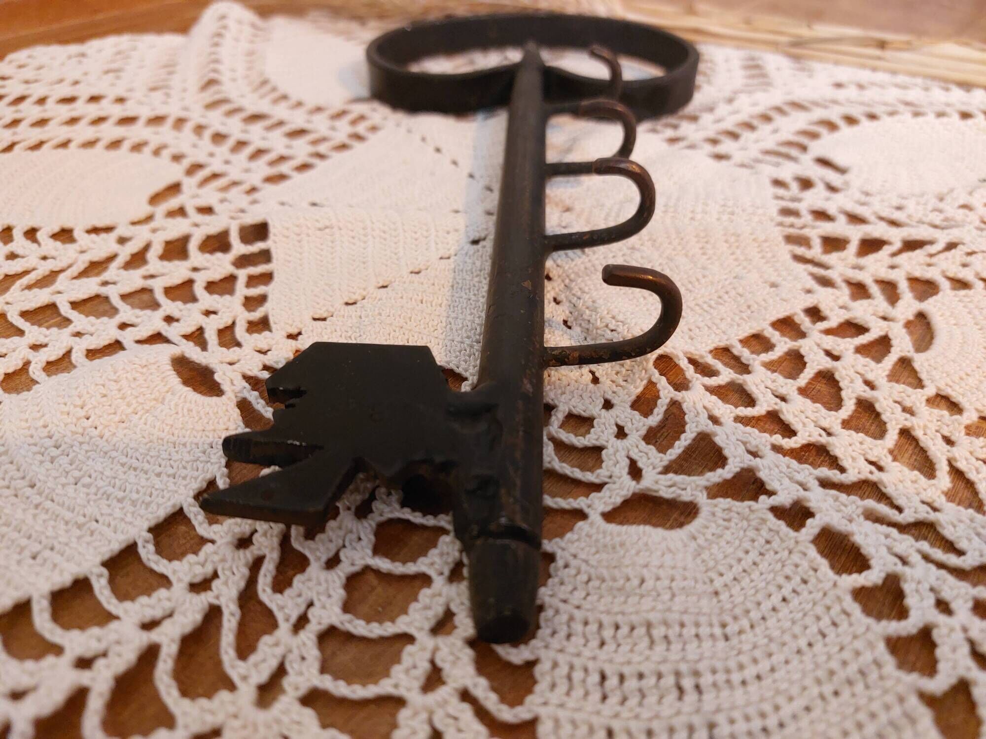 Old wall key holder in the shape of a vintage metal key 4 hooks