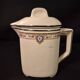 Old covered jug, vintage, geometric frieze with flowers and black trim.