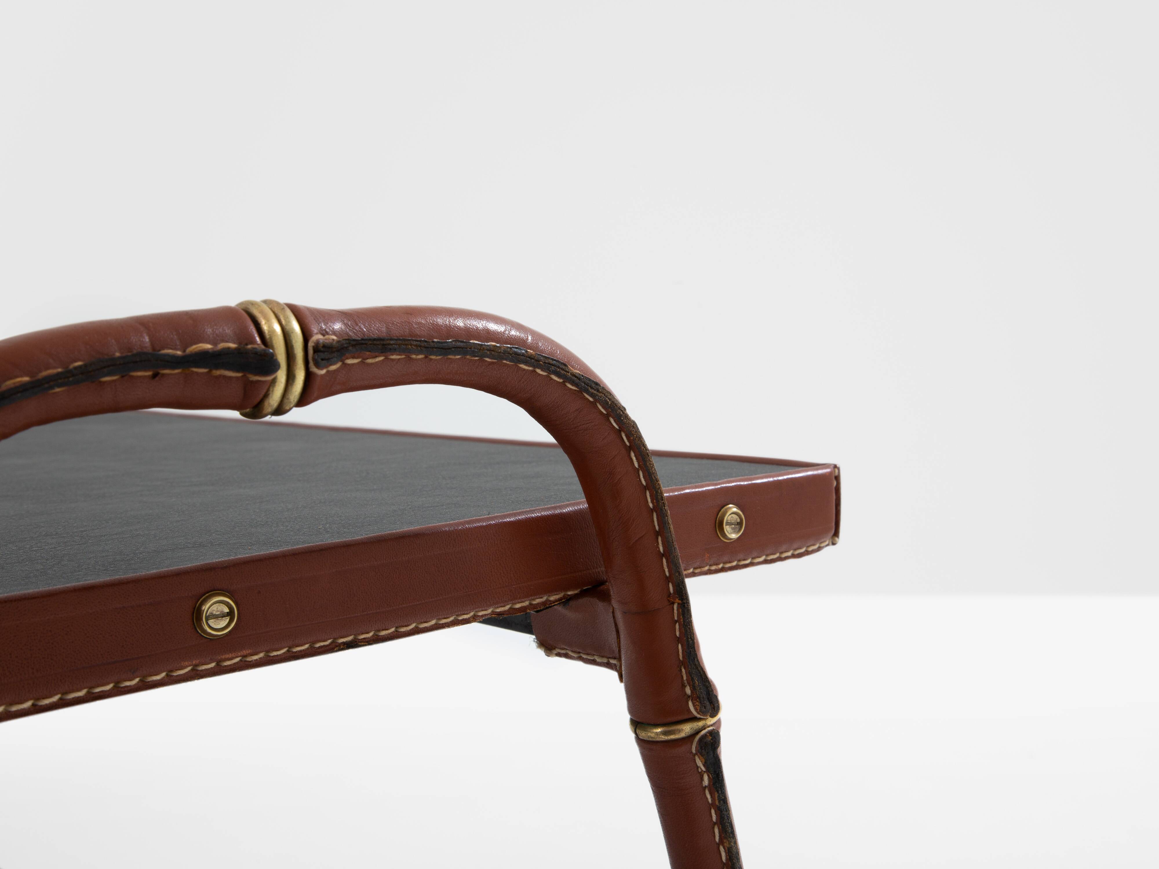 Jacques Adnet coffee table in red saddle-stitched leather and brass, 1950s
