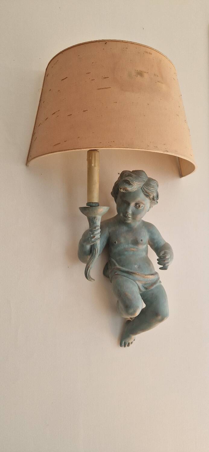 Pairs of wall lights, either two distinct cherubs.