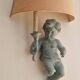 Pairs of wall lights, either two distinct cherubs.